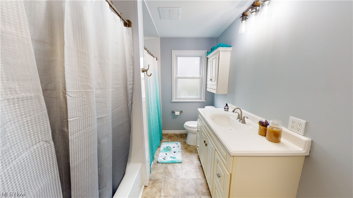 1331 Churchill Road Lyndhurst, OH 44124 - Photo 8 of 35 Full bathroom featuring vanity, toilet, tile floors, and shower / tub combo with curtain