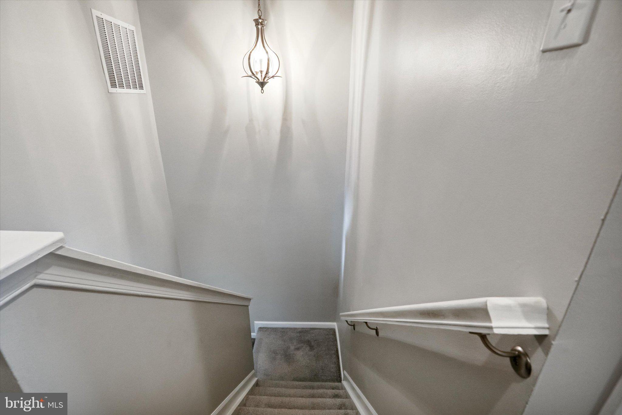 9663 Davison Road Middle River, MD 21220 - Photo 13 of 45 Inviting staircase with elegant lighting.