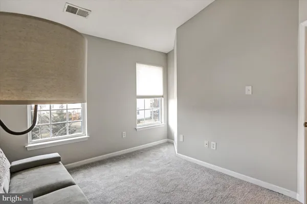 an empty room with windows lake and mountain view