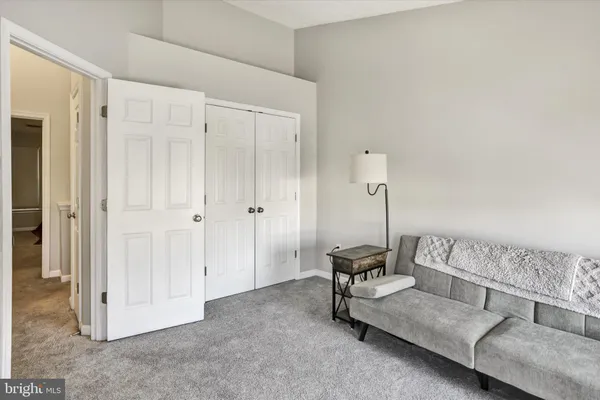 a living room with furniture and a lamp