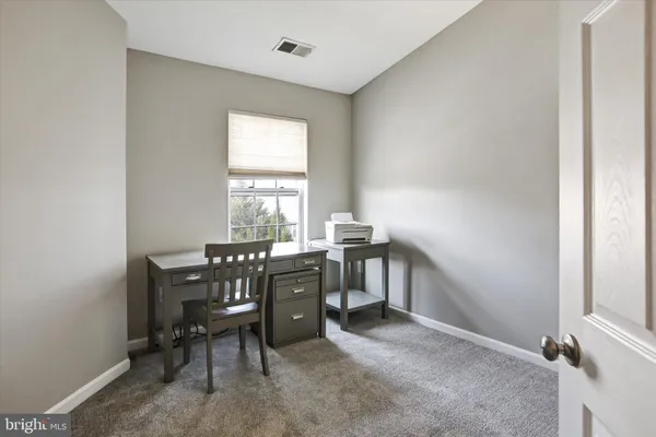 a view of workspace with furniture and window