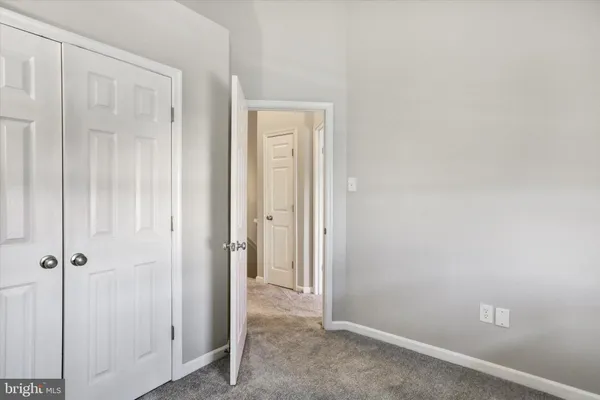 an empty room with closet area