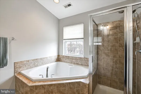 a bathroom with a tub and shower