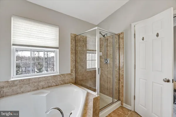 a bathroom with a granite countertop window and a shower