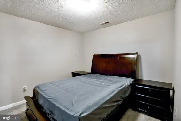 a bedroom with a bed and dresser