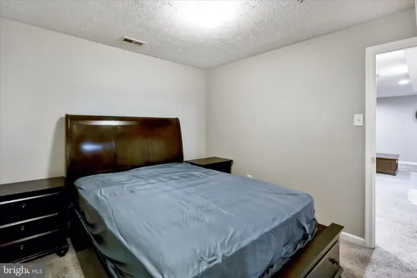 a bedroom with a bed and lamp