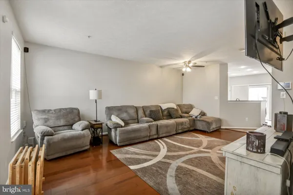 a living room with furniture and a mirror