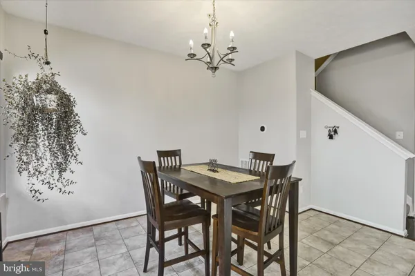 a view of a dining room with furniture and chandelier