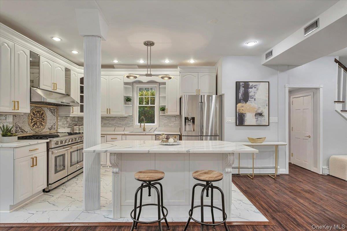 193 Nelson Road Scarsdale, NY 10583 - Photo 9 of 37 a kitchen with stainless steel appliances kitchen island granite countertop a stove and cabinets
