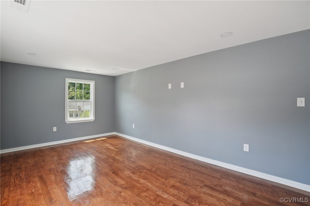1133 Rome Street Petersburg, VA 23803 - Photo 32 of 33 Empty room with wood finished floors and baseboard