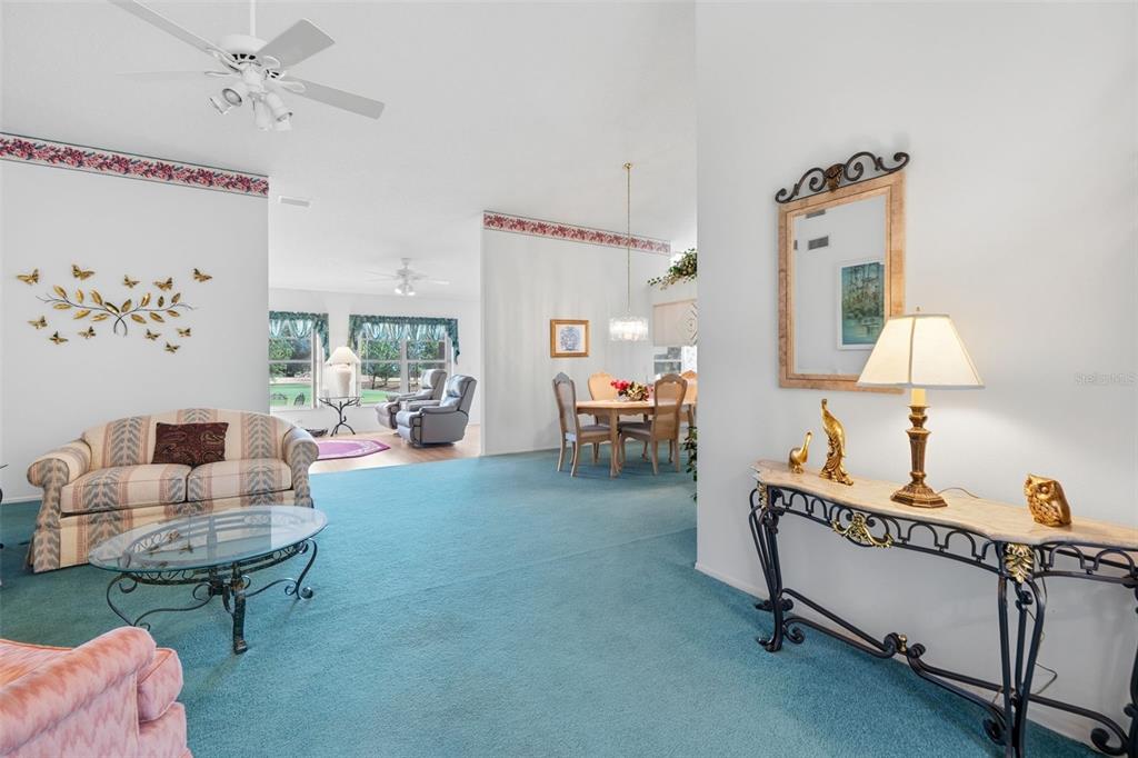 7354 Woodhollow Road Spring Hill, FL 34606 - Photo 11 of 47 a living room with furniture and a table