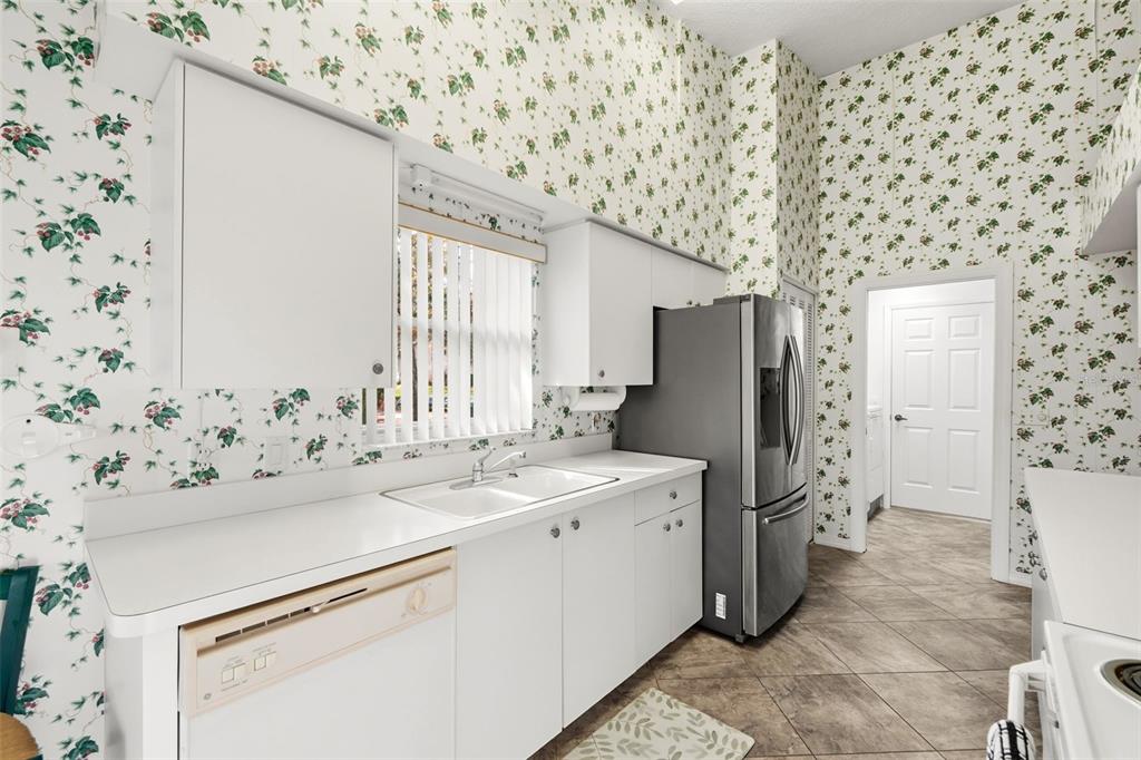 7354 Woodhollow Road Spring Hill, FL 34606 - Photo 15 of 47 a utility room with cabinets washer and dryer