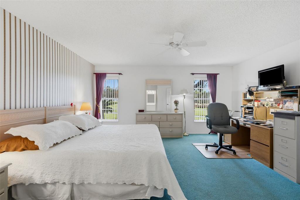 7354 Woodhollow Road Spring Hill, FL 34606 - Photo 26 of 47 a bedroom with a workspace