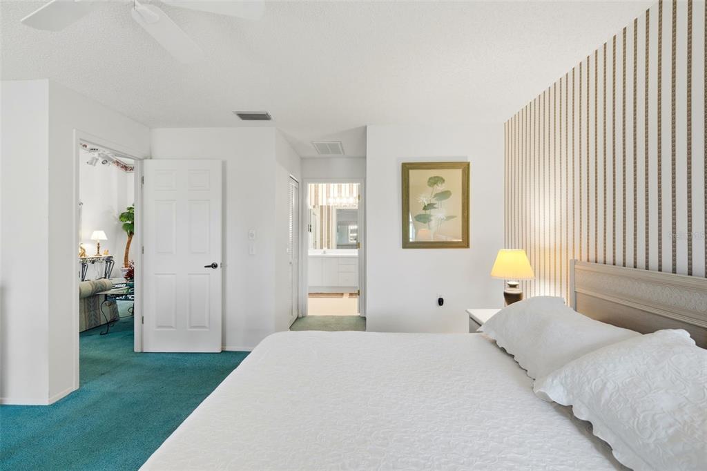 7354 Woodhollow Road Spring Hill, FL 34606 - Photo 27 of 47 a bedroom with a bed and a chandelier