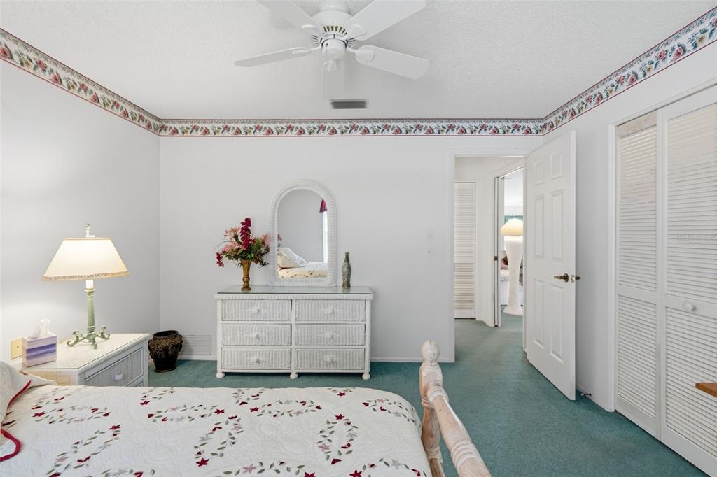 7354 Woodhollow Road Spring Hill, FL 34606 - Photo 30 of 47 a bedroom with a bed and a chandelier