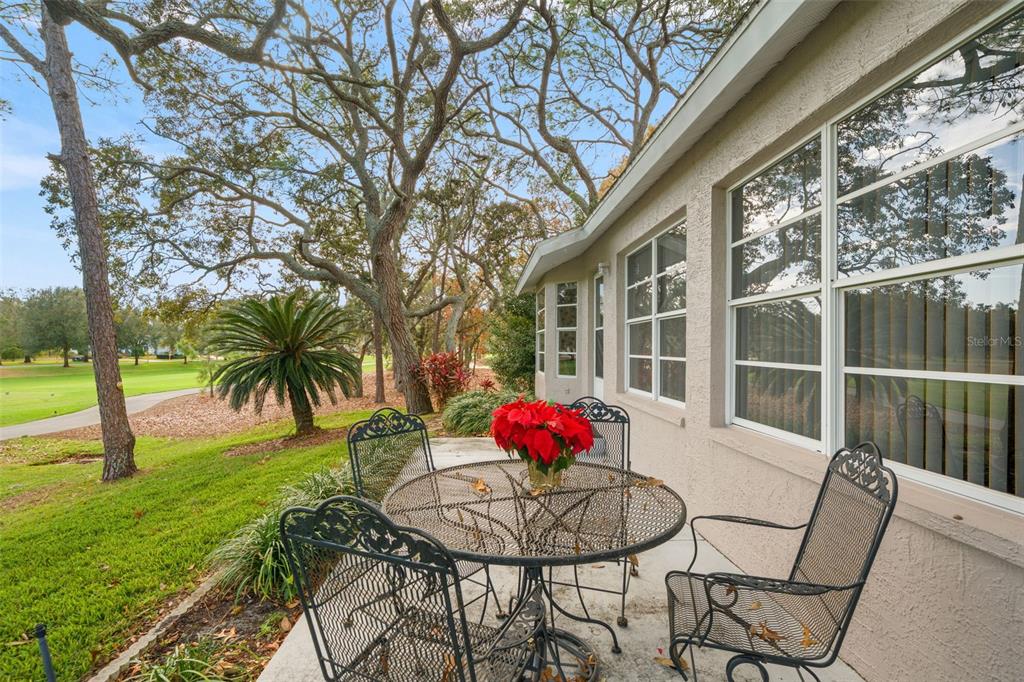 7354 Woodhollow Road Spring Hill, FL 34606 - Photo 36 of 47 a view of outdoor dining space with a table and chairs