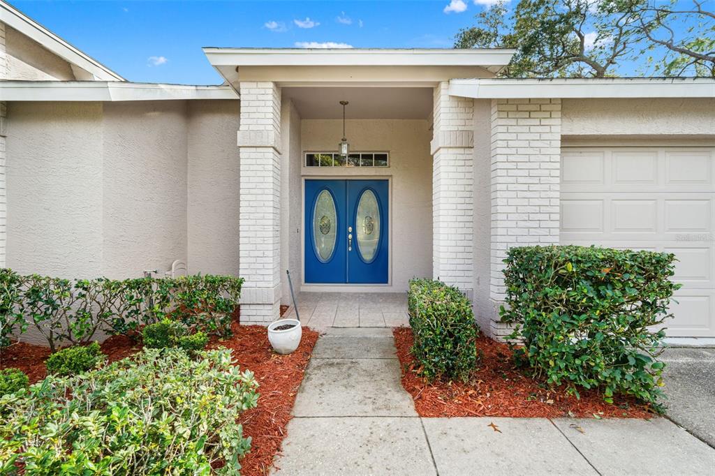 7354 Woodhollow Road Spring Hill, FL 34606 - Photo 4 of 47 a front view of a house with garden