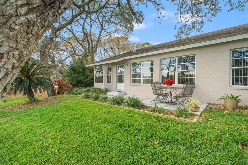 7354 Woodhollow Road Spring Hill, FL 34606 - Photo 45 of 47 a house view with a seating space and garden