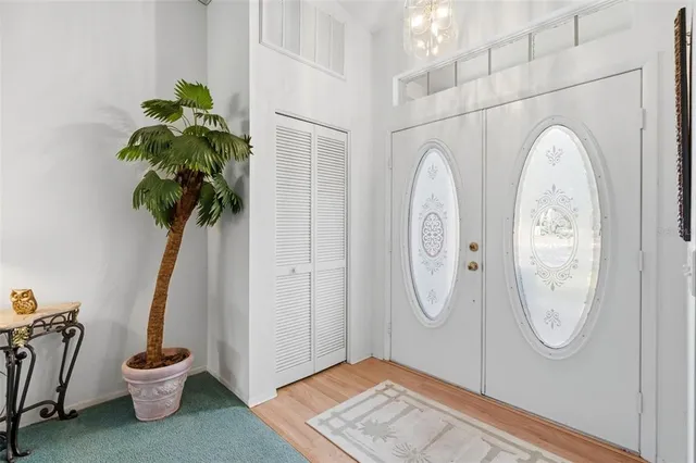 a vase with flowers sitting on a table in a room