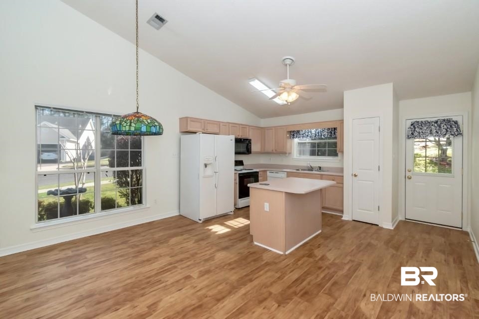 672 Spring Lake Drive East Mobile, AL 36695 - Photo 22 of 26 Kitchen featuring visible vents, black microwave, light countertops, range with electric stovetop, and white refrigerator with ice dispenser