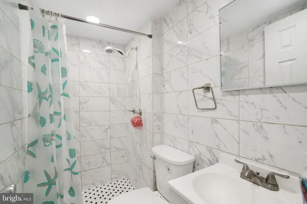 a bathroom with a toilet sink and shower
