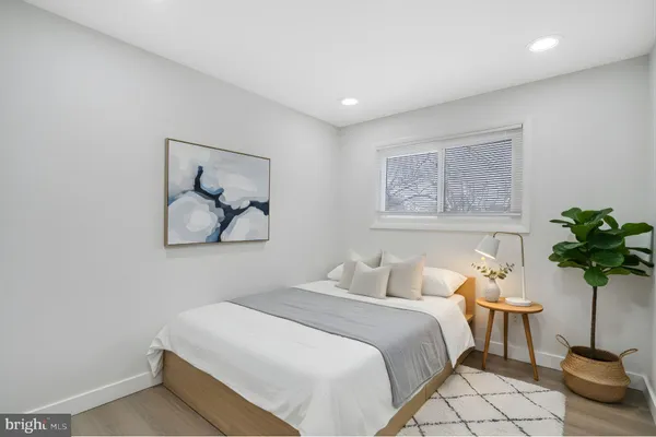 a bedroom with a bed and a potted plant