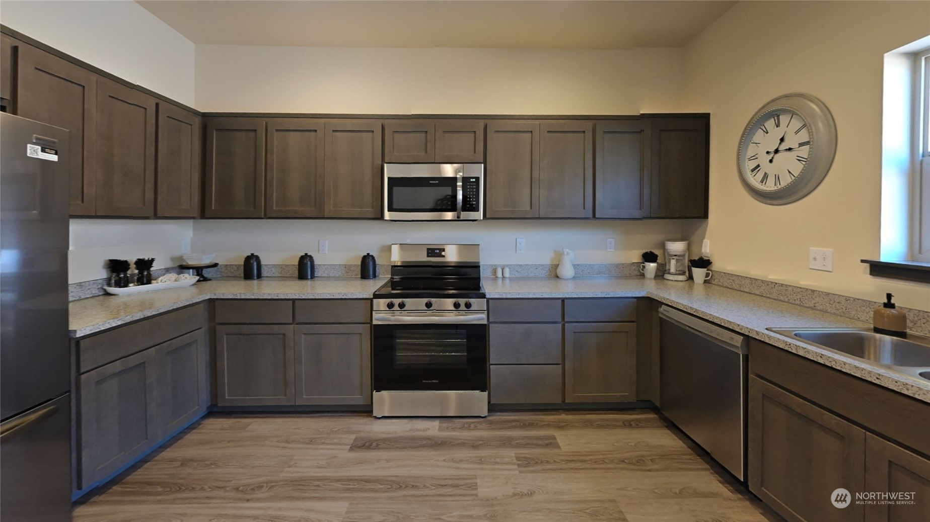 3651 Pine Road Northeast Bremerton, WA 98310 - Photo 14 of 29 a kitchen with a sink cabinets and stainless steel appliances