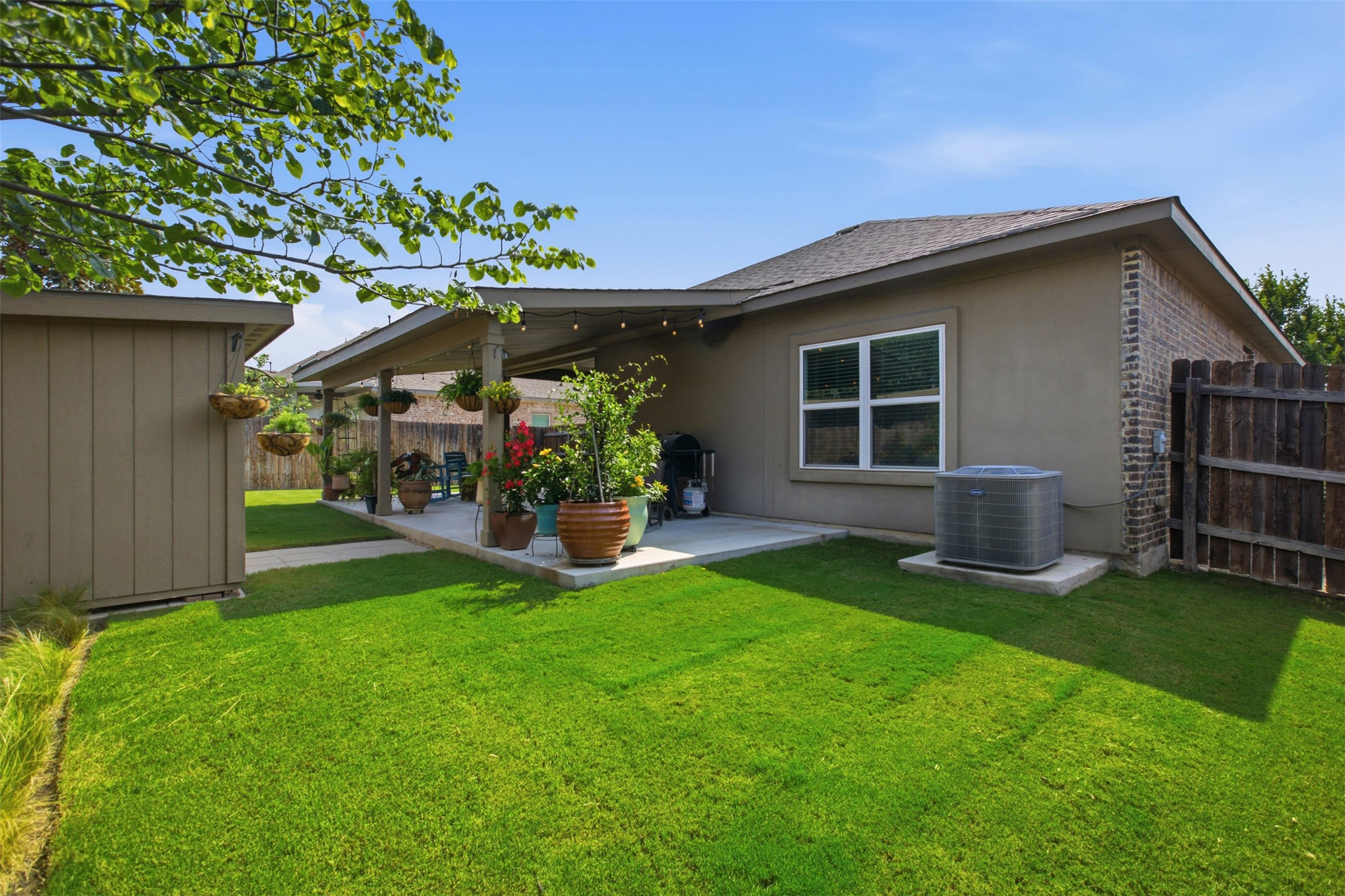 2413 Bridges Ranch Road Georgetown, TX 78628 - Photo 29 of 31 Generous backyard features a covered patio perfect for outdoor enjoyment and entertaining.