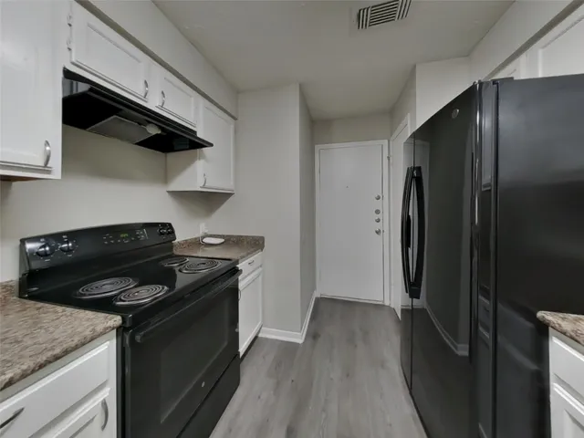 a kitchen with a stove and a refrigerator