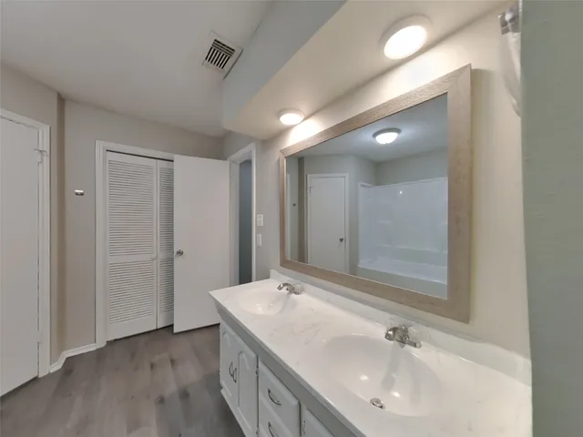 a bathroom with a sink and a large mirror