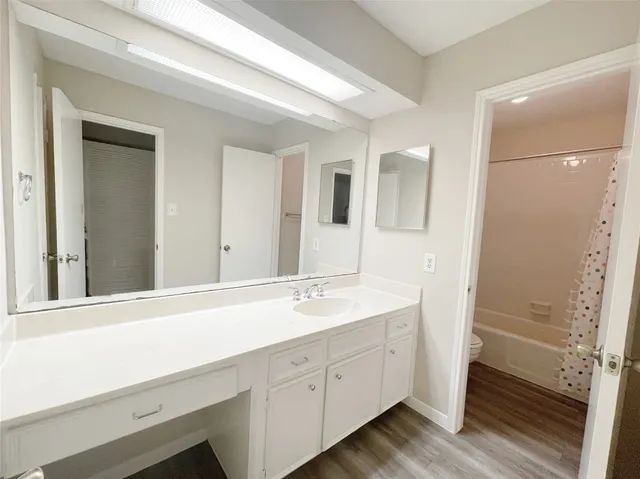 a spacious bathroom with a double vanity sink and mirror