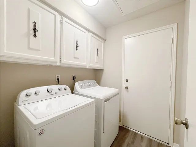 a view of storage and utility room with washer and dryer