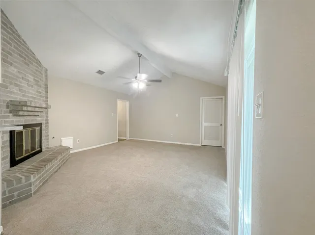 a view of an empty room with a fireplace