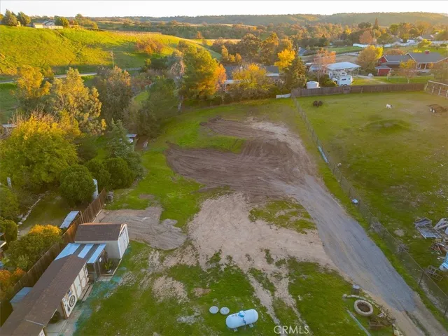 a view of a big yard with swimming pool and green space
