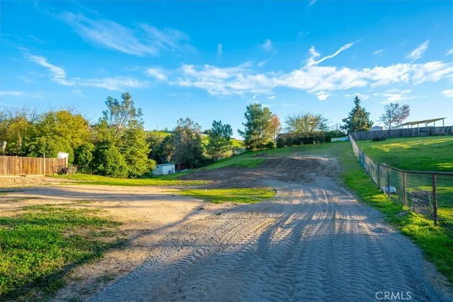 a view of a house with backyard and a tree