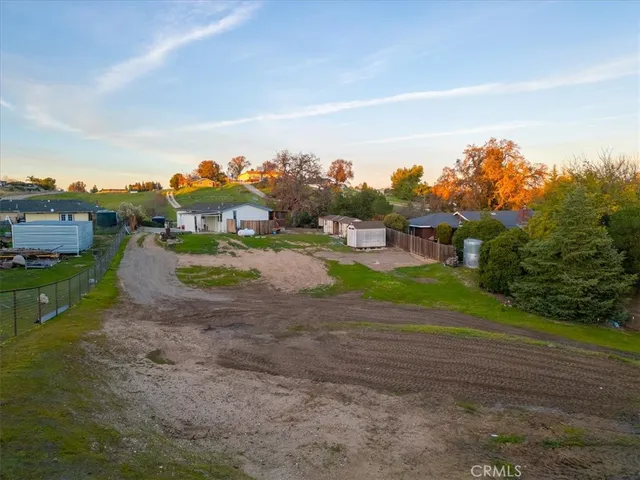 an aerial view of a house with a yard and lake view