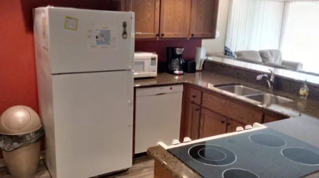 a kitchen with a sink and a refrigerator