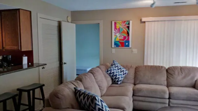 a living room with furniture a couch and a window