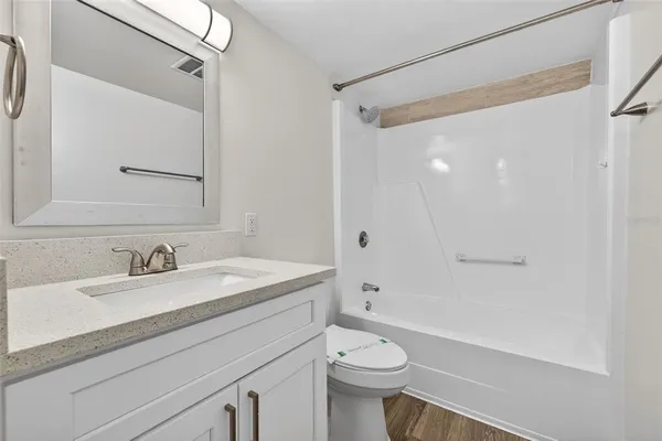 a bathroom with a sink a toilet and a large mirror