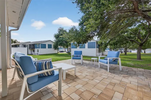 a chair and table sitting in backyard of a house