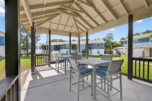 a view of a patio with a table chairs and backyard