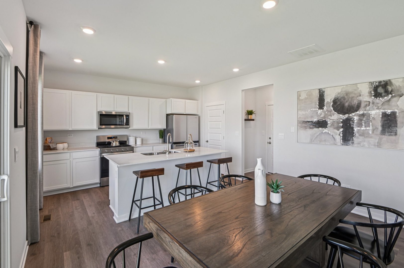 500 Arbor Ridge Drive Hampshire, IL 60140 - Photo 6 of 46 a kitchen with stainless steel appliances granite countertop a table chairs microwave and cabinets
