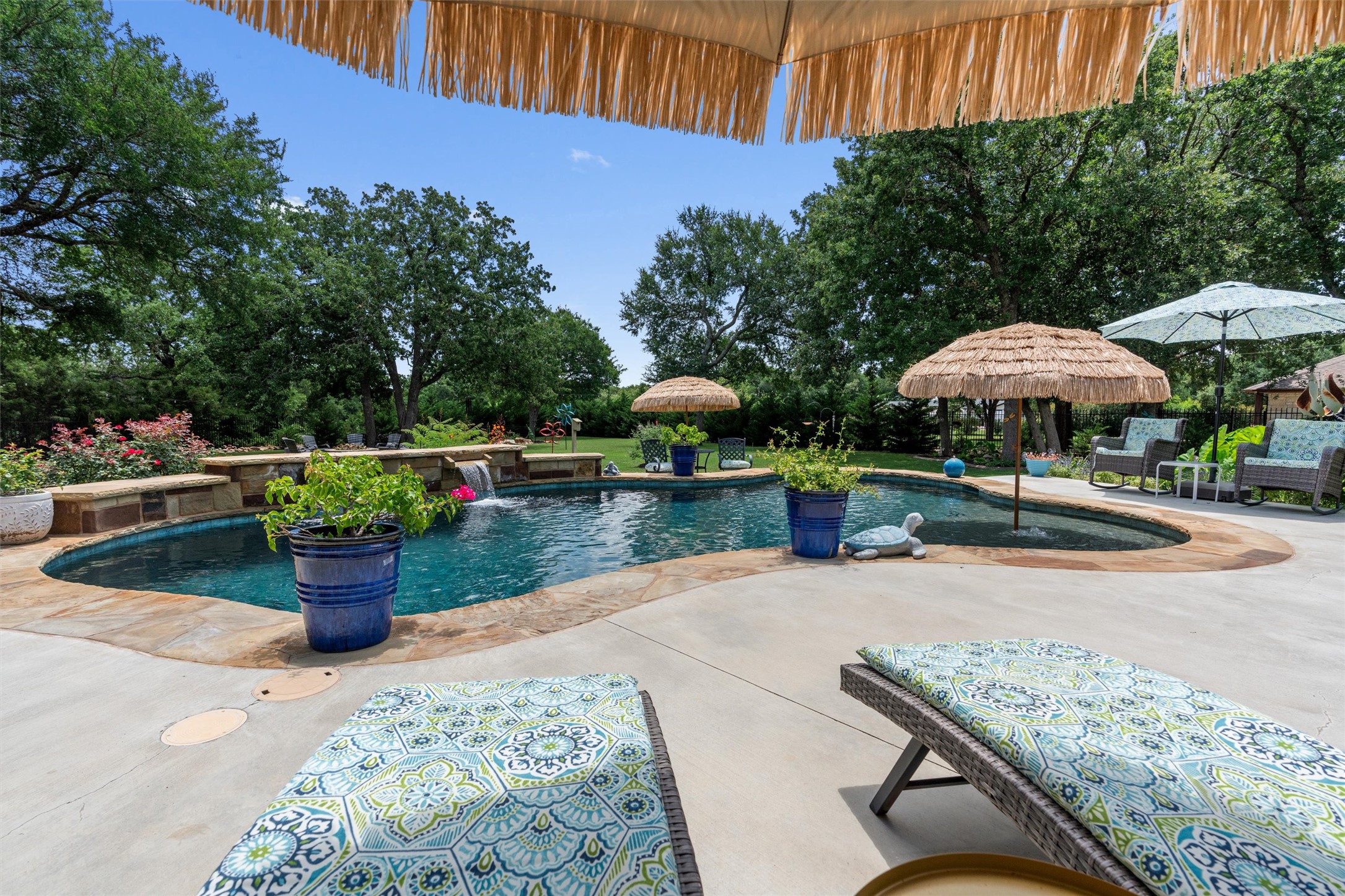 104 Adobe Cove Georgetown, TX 78633 - Photo 32 of 40 A tranquil oasis featuring a sparkling pool with a gentle waterfall, perfect for relaxation and outdoor enjoyment.
