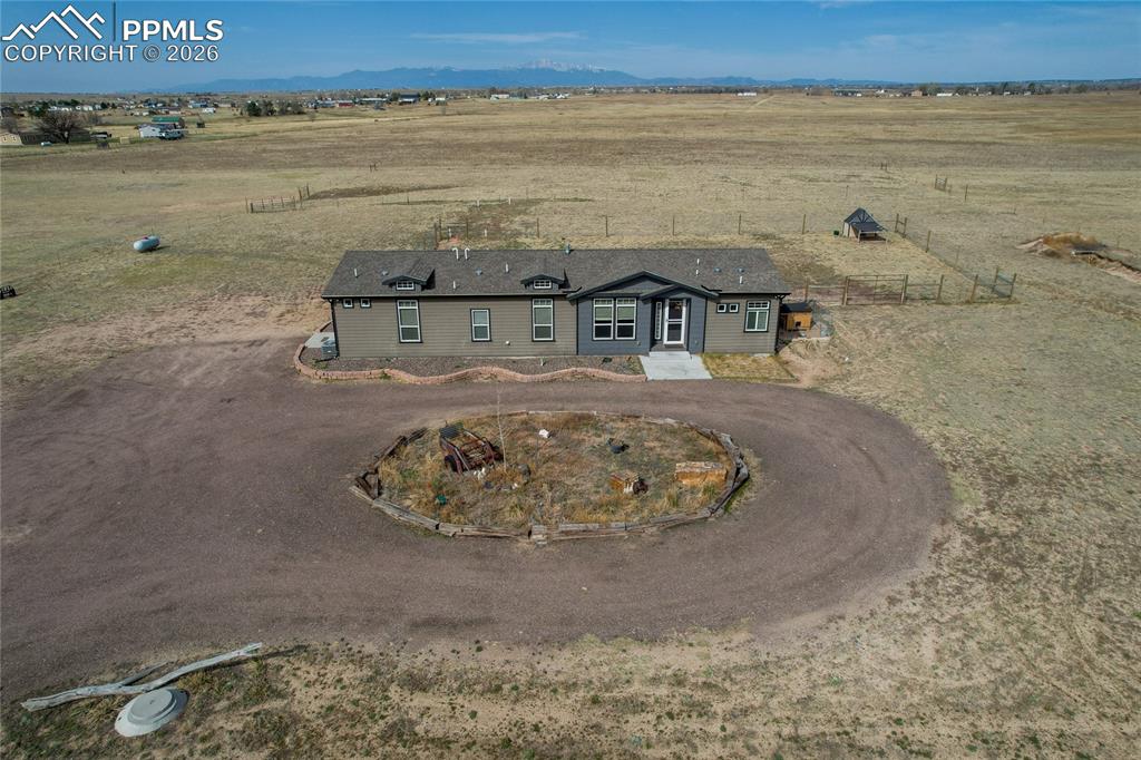 7880 J D Johnson Road Peyton, CO 80831 - Photo 1 of 50 Single-story residence featuring a gray and tan exterior with a gabled roofline and multiple dormer windows