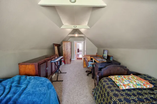 a view of bedroom with furniture and a chandelier