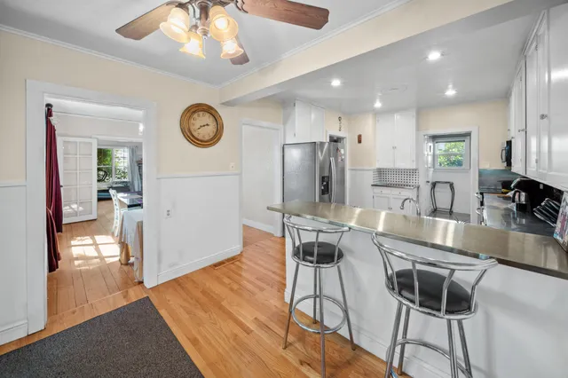 a kitchen with stainless steel appliances granite countertop a refrigerator and a stove top oven