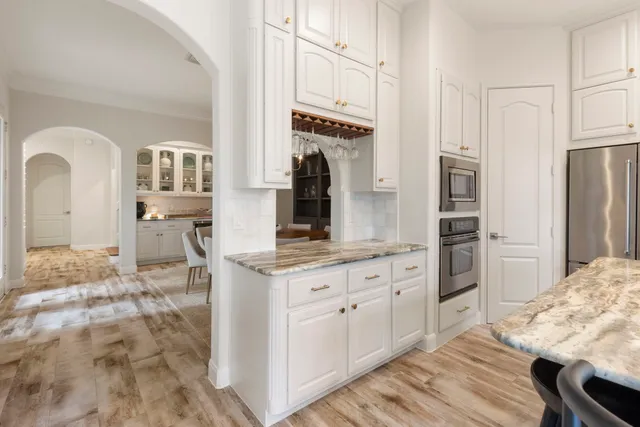 a kitchen with stainless steel appliances kitchen island granite countertop a refrigerator and microwave