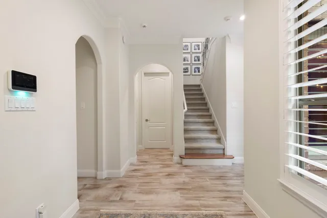 a view of a hallway with stairs and a window