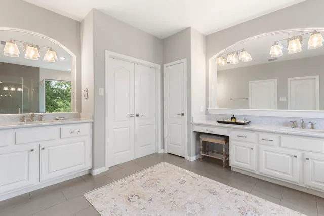 a spacious bathroom with a sink double vanity and a mirror