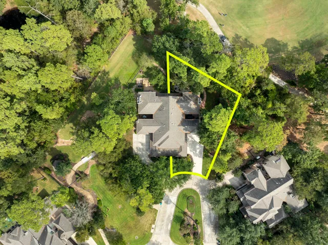 an aerial view of a house with a yard